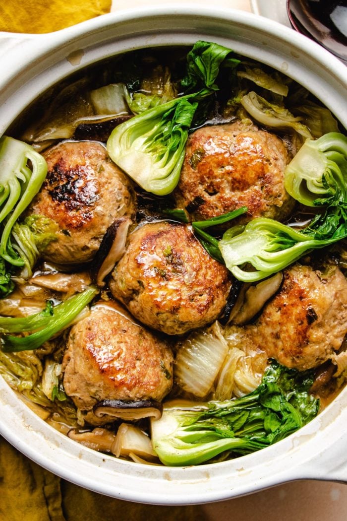 Photo shows jumbo meatballs and napa cabbage stew in a big white clay pot